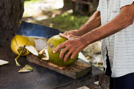 Man cutting coconut for coconut water | Coconut water benefits